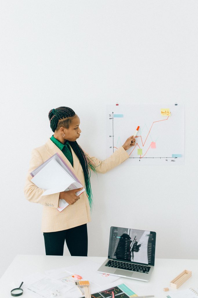 Illustrative business image: a presenter discussing a chart
